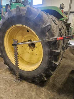 Torque tree supporting a long extension while a 3/4-inch drive torque wrench torques a large tractor wheel bolt