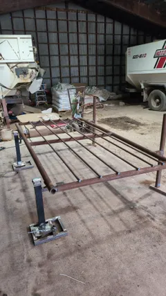 Panel frame laid flat in the shop during fabrication, rails tacked in place on jack stands